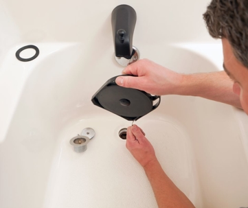 man checking a clogged drain